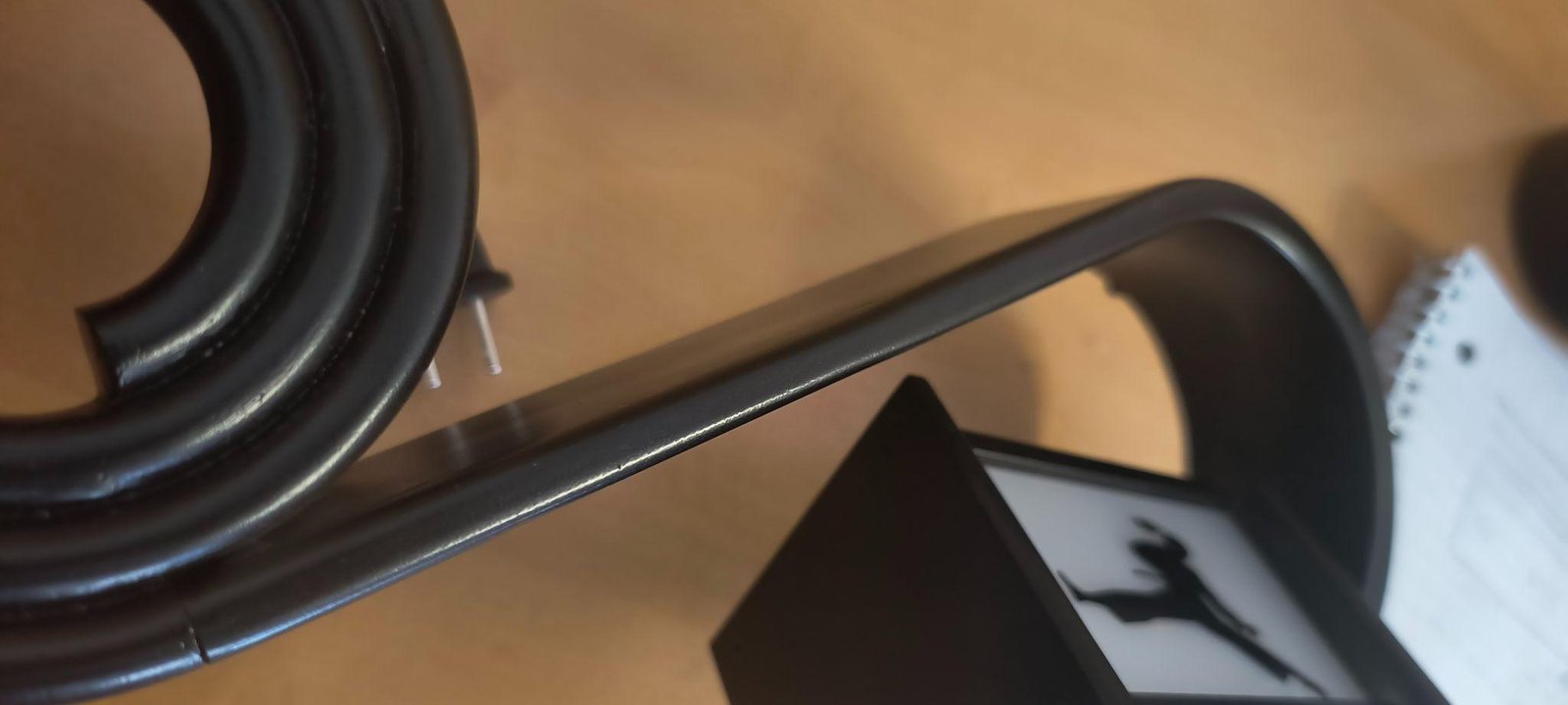 A close-up of the finished arm, its rounded edge blending into the flat face.